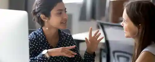 Two women talking over coffee
